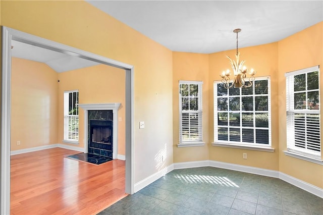 unfurnished dining area with a fireplace, plenty of natural light, and hardwood / wood-style floors