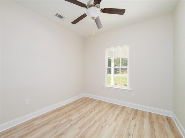 empty room with ceiling fan and light hardwood / wood-style flooring