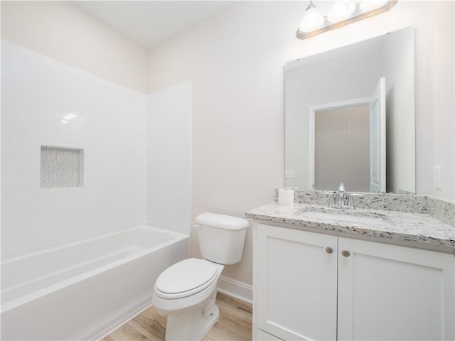 full bathroom with hardwood / wood-style floors, vanity, toilet, and shower / tub combination