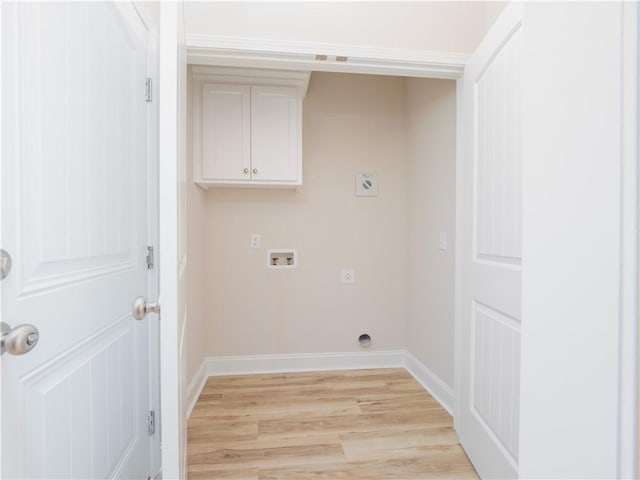 laundry area with hookup for an electric dryer, cabinets, hookup for a washing machine, and light hardwood / wood-style flooring