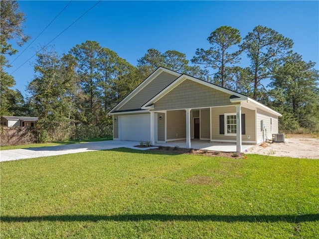 view of front of house with cooling unit, a front lawn, covered porch, and a garage