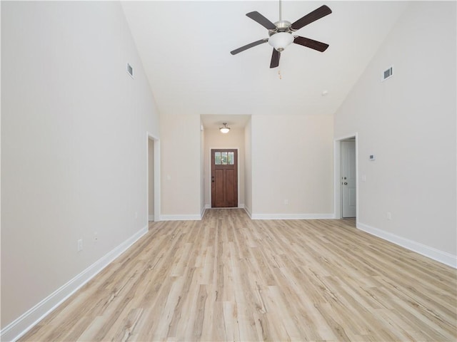 unfurnished living room featuring ceiling fan, high vaulted ceiling, and light wood-type flooring