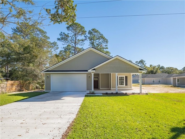 view of front of home with a front yard, a garage, and covered porch