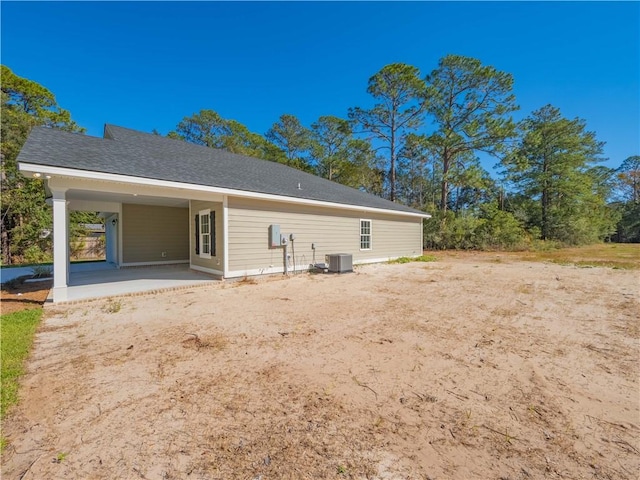 rear view of property with cooling unit