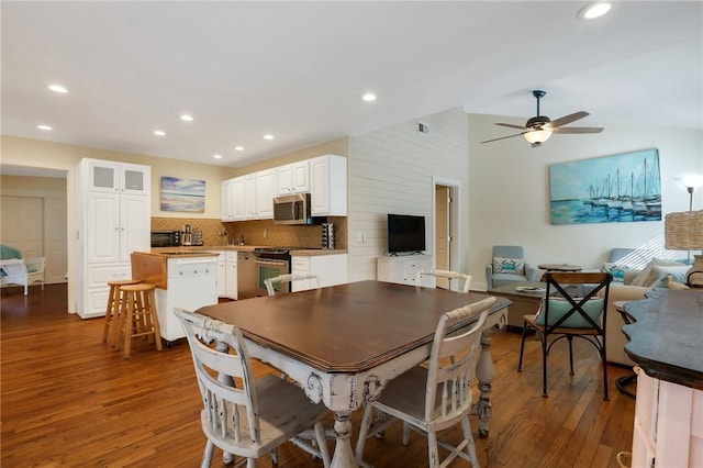 dining room featuring vaulted ceiling, ceiling fan, and dark hardwood / wood-style floors