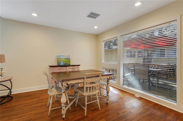 dining space with dark hardwood / wood-style flooring