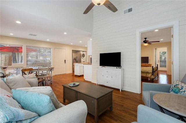 living room featuring ceiling fan and dark hardwood / wood-style flooring