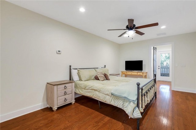 bedroom featuring access to exterior, ceiling fan, and dark wood-type flooring