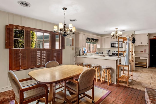 1001 Coral Rd, Waycross, GA 31501 - dining room featuring a chandelier and brick floors
