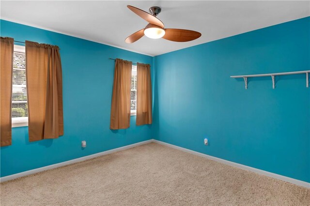 1001 Coral Rd, Waycross, GA 31501 - carpeted empty room with a ceiling fan and baseboards