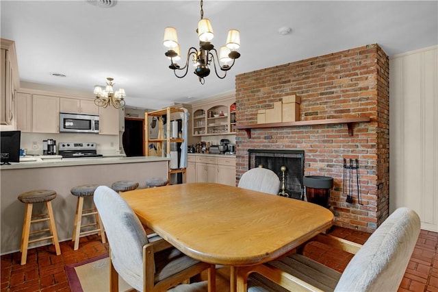 1001 Coral Rd, Waycross, GA 31501 - dining room with a chandelier, brick flooring, and a brick fireplace