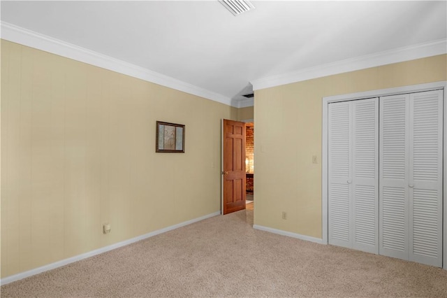 1001 Coral Rd, Waycross, GA 31501 - unfurnished bedroom featuring carpet flooring, crown molding, baseboards, and a closet