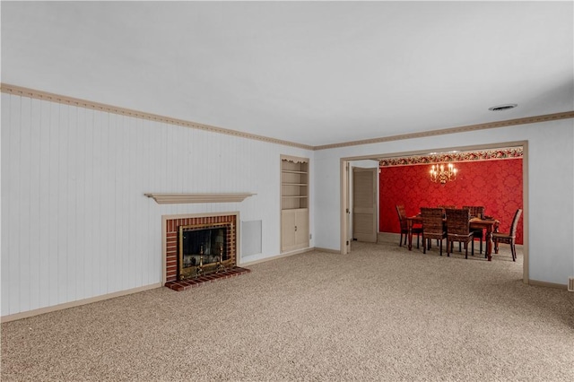 1001 Coral Rd, Waycross, GA 31501 - living room with carpet floors, baseboards, a chandelier, a brick fireplace, and ornamental molding