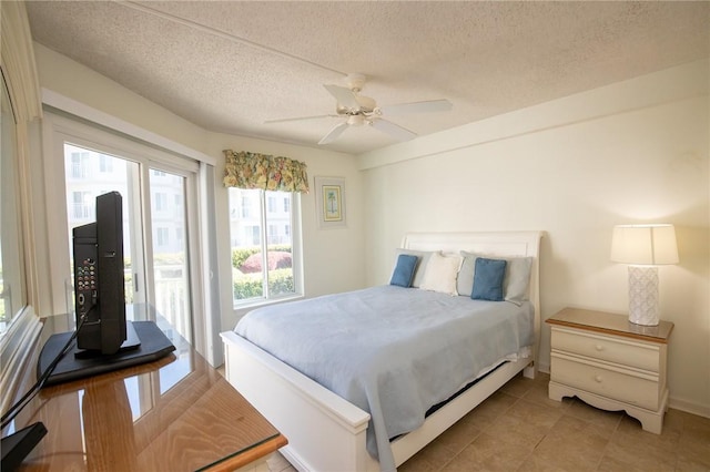 bedroom featuring light tile patterned floors, a textured ceiling, access to exterior, and a ceiling fan