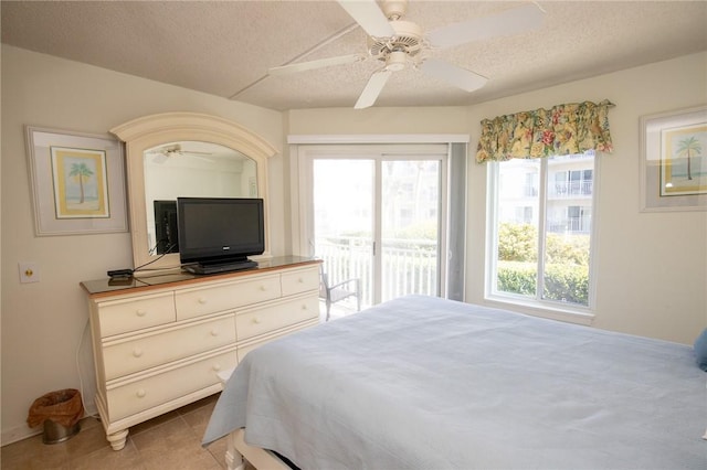 bedroom with a textured ceiling, ceiling fan, light tile patterned flooring, and access to outside