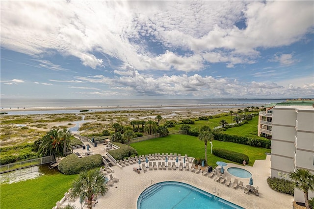 community pool featuring a patio and a water view