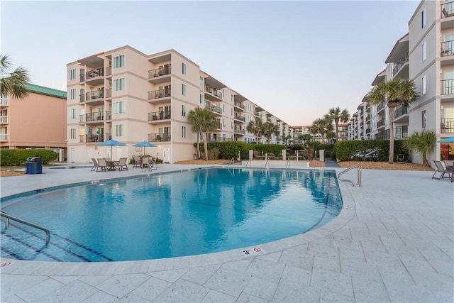 community pool with a patio area