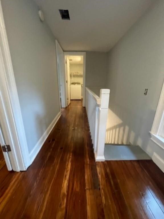 corridor with dark hardwood / wood-style floors