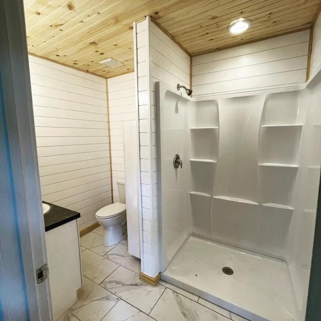 bathroom with a shower, vanity, wood walls, and wood ceiling