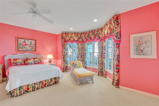 carpeted bedroom with ceiling fan and ornamental molding