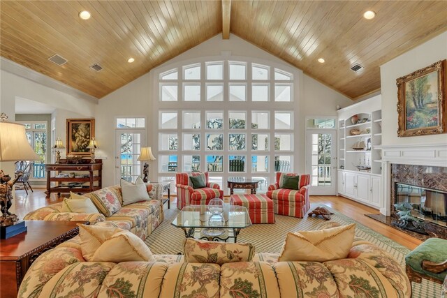 living room with wood ceiling, a healthy amount of sunlight, and light hardwood / wood-style floors