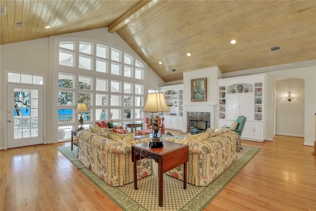 living room with a premium fireplace, high vaulted ceiling, beamed ceiling, wood ceiling, and light wood-type flooring