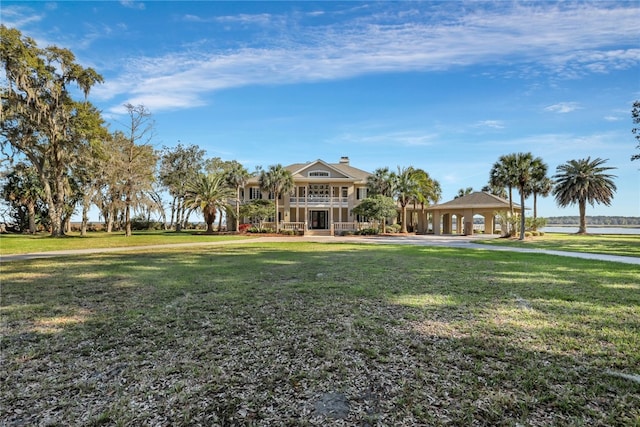 view of front of property featuring a front yard and a gazebo