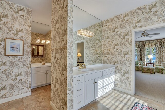 bathroom with ceiling fan and vanity