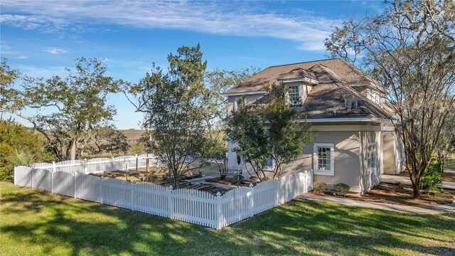 back of property featuring a lawn