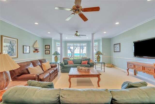 living room featuring ornate columns, crown molding, ceiling fan, and light carpet