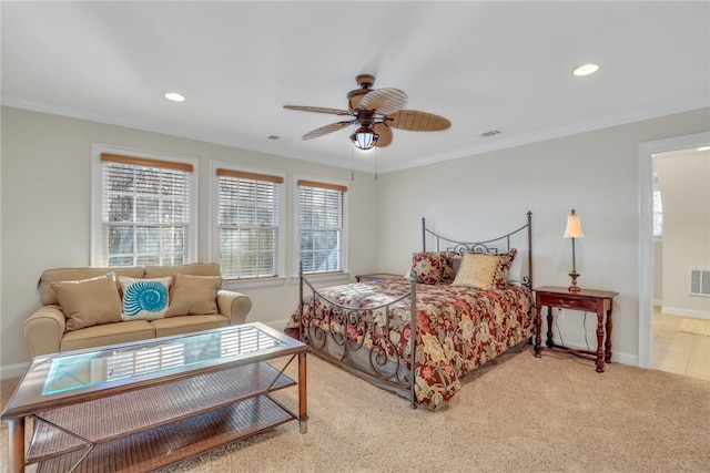 carpeted bedroom with ceiling fan and crown molding