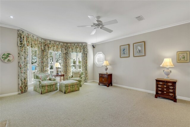 sitting room with crown molding, carpet, and ceiling fan