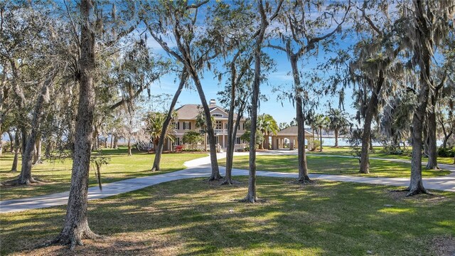 view of property's community with a lawn