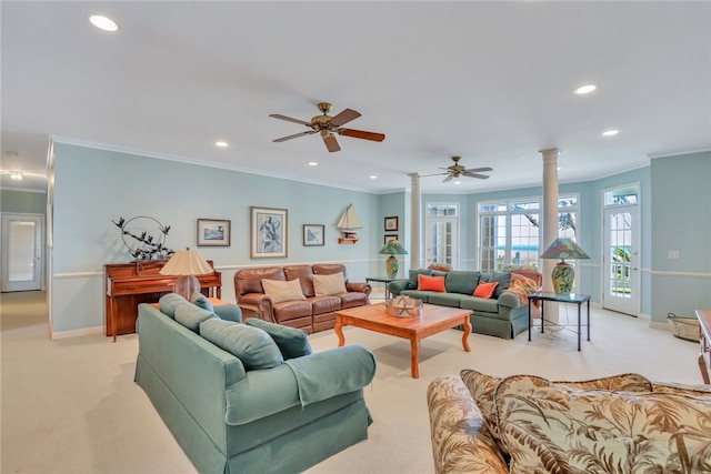 living room with ceiling fan, light colored carpet, crown molding, and decorative columns