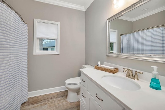 bathroom featuring baseboards, toilet, wood finished floors, crown molding, and vanity