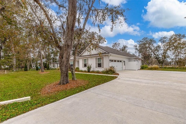 view of front of property with a garage, driveway, and a front lawn