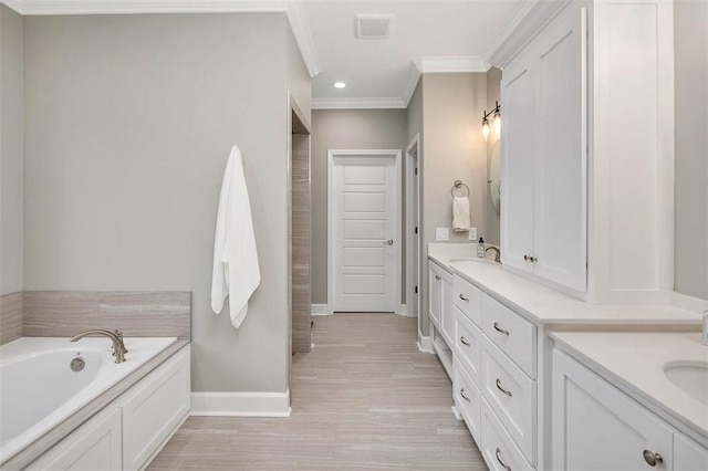 full bath with ornamental molding, a garden tub, vanity, and baseboards