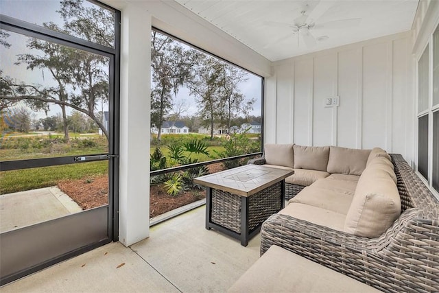 sunroom featuring ceiling fan