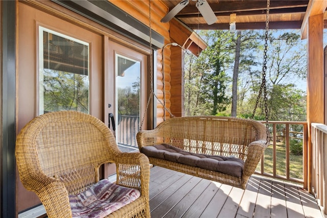 exterior space featuring beamed ceiling, plenty of natural light, and a ceiling fan