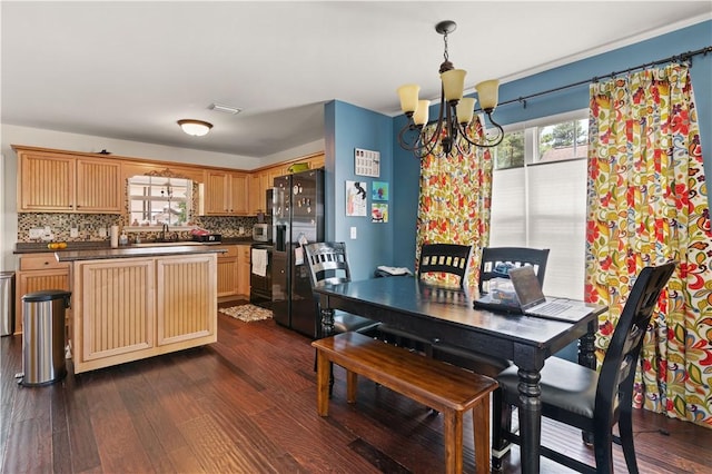 dining area with a notable chandelier, visible vents, and dark wood-style flooring