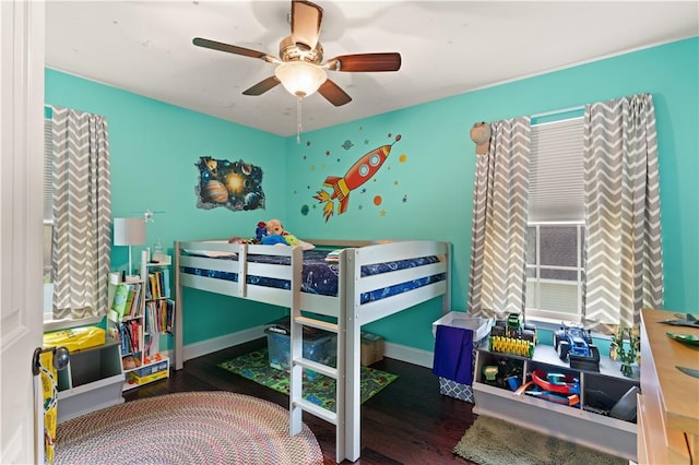 bedroom featuring ceiling fan, wood finished floors, and baseboards