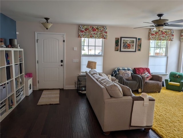 living room with baseboards, ceiling fan, wood finished floors, and a healthy amount of sunlight