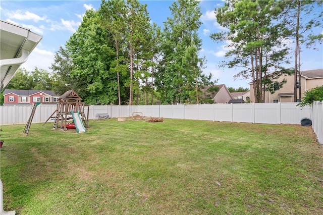 view of yard with a fenced backyard and a playground