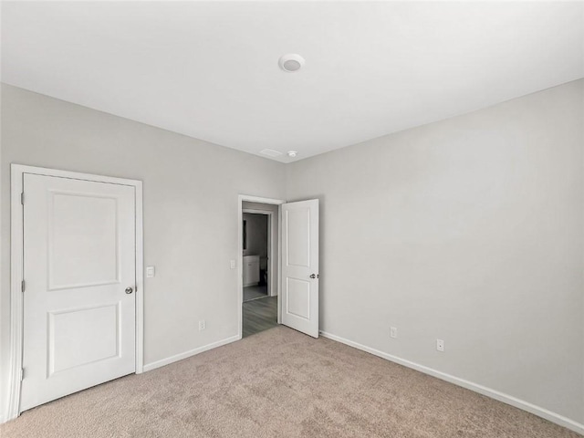 unfurnished bedroom with baseboards and carpet flooring