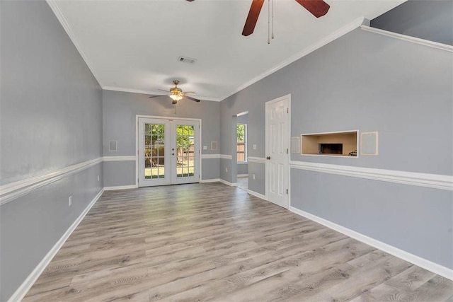 unfurnished living room with crown molding, a ceiling fan, french doors, and visible vents