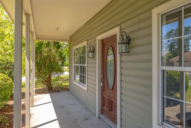 entrance to property featuring covered porch and a water view