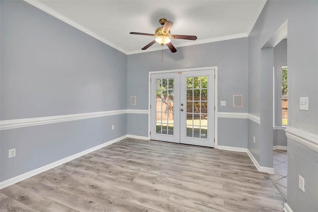 spare room with baseboards, french doors, ceiling fan, and wood finished floors