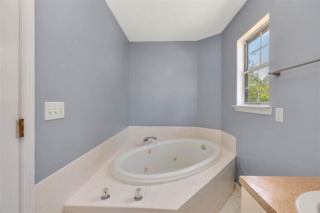 bathroom featuring a whirlpool tub and vanity