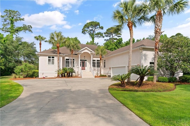 ranch-style home with stucco siding, an attached garage, a front lawn, and driveway