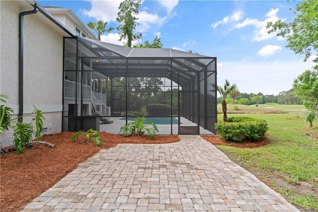 view of patio / terrace with glass enclosure and an outdoor pool